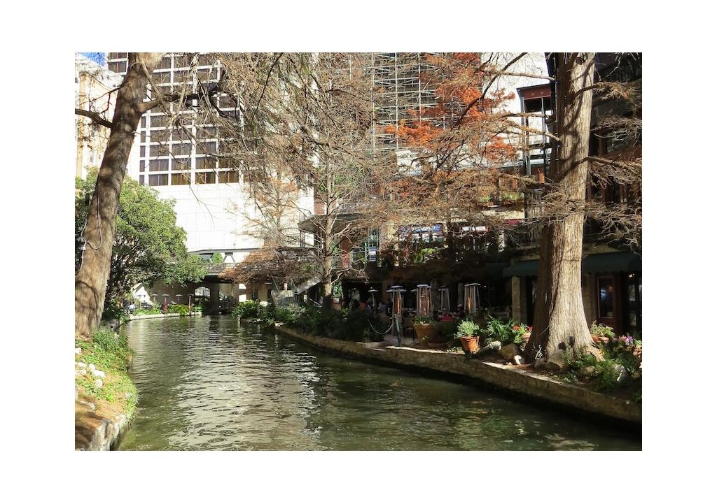 Riverwalk pathways among restaurants and buildings.